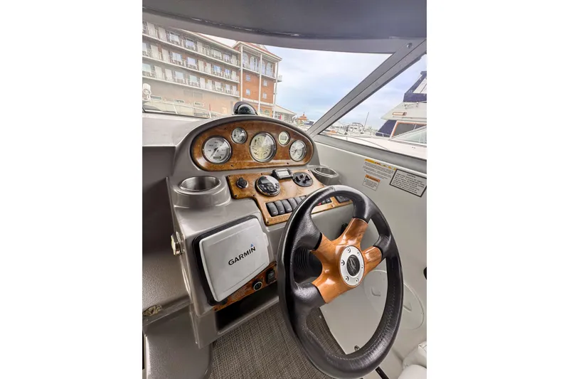 Slide: The Image of 2007 Rinker 270 Express Cruiser dashboard with Garmin GPS and wood-accented steering wheel. - 5