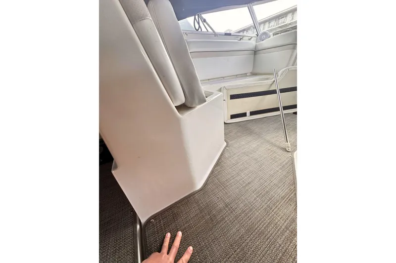 Slide: The Image of Interior of a 2007 Rinker 270 Express Cruiser boat, featuring seating and carpeted flooring. - 6