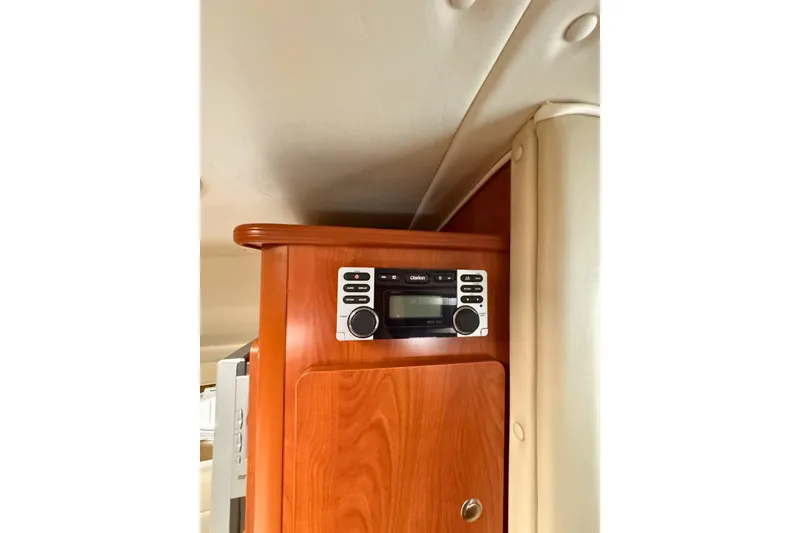 Slide: The Image of 2007 Rinker 270 Express Cruiser interior with wood paneling and stereo system. - 9