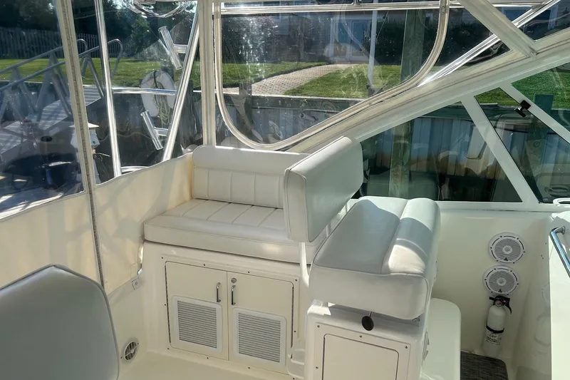 Slide: The Image of Interior of 2012 Cabo 32 Express boat with white seating and clear windows. - 10