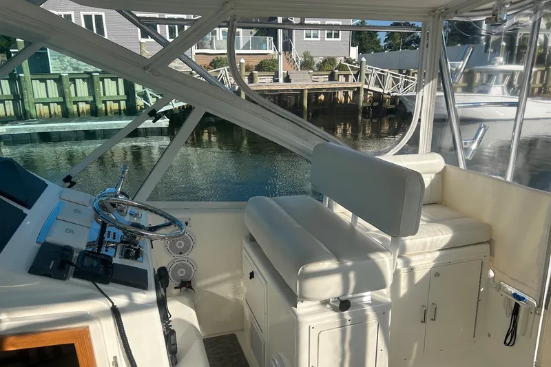 Slide: The Image of Interior view of 2012 Cabo 32 Express boat with helm and seating area. - 11