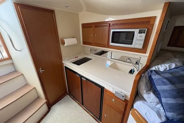 Slide: The Image of Interior of 2012 Cabo 32 Express boat with seating area and table. - 21