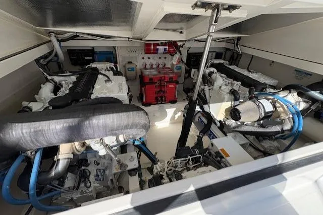 Slide: The Image of Engine room of a 2012 Cabo 32 Express boat, featuring dual engines and equipment. - 26