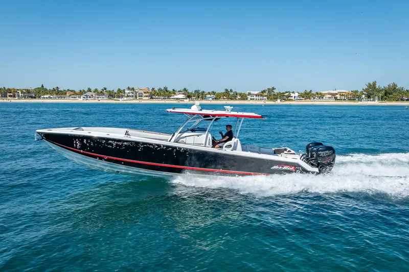 The Image of 2018 Nor-Tech 390 Sport Center Console boat cruising on blue ocean waters. - 0