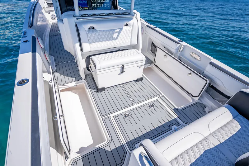 Slide: The Image of 2018 Nor-Tech 390 Sport Center Console boat interior with seating and storage compartments. - 11