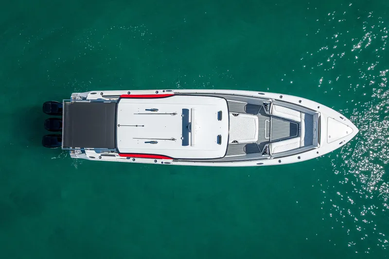 Slide: The Image of Overhead view of 2018 Nor-Tech 390 Sport Center Console on turquoise water. - 16