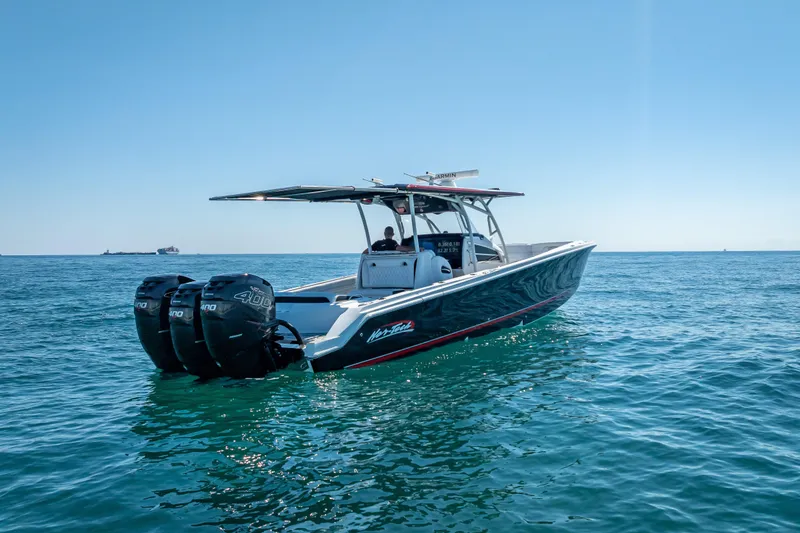 Slide: The Image of 2018 Nor-Tech 390 Sport Center Console boat on open water, clear sky. - 19