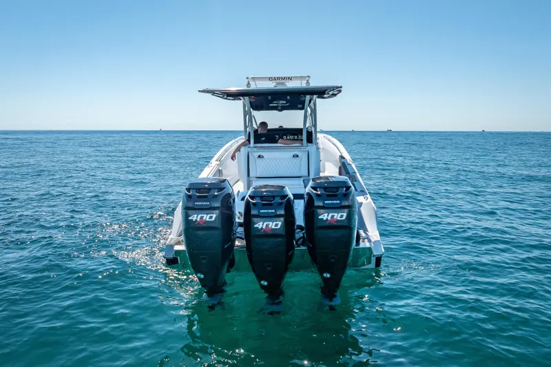 Slide: The Image of 2018 Nor-Tech 390 Sport Center Console with triple 400 engines on open water. - 20