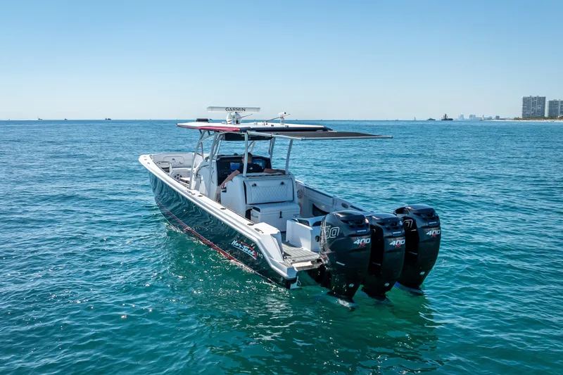 Slide: The Image of 2018 Nor-Tech 390 Sport Center Console boat on open water, featuring triple 400 horsepower engines. - 21