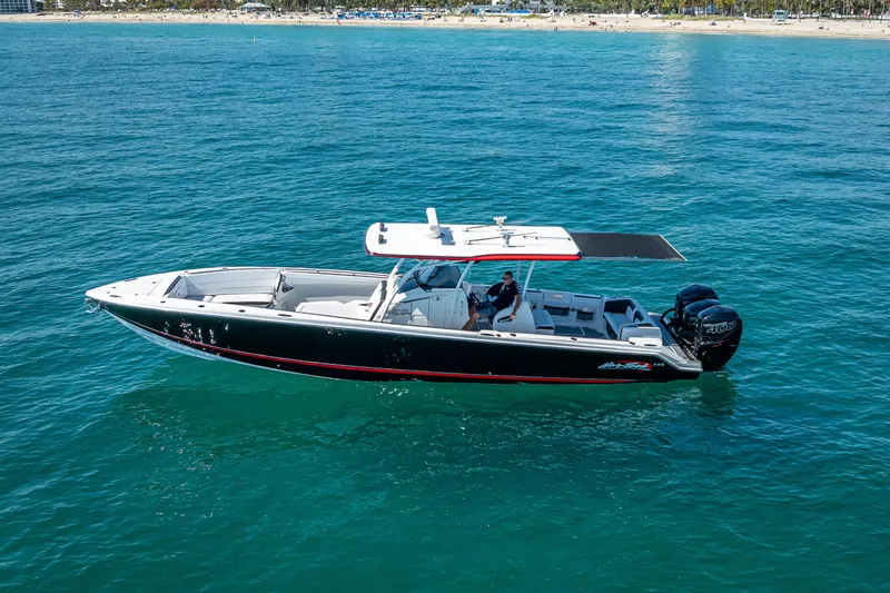 Slide: The Image of 2018 Nor-Tech 390 Sport Center Console boat cruising on clear blue water. - 23