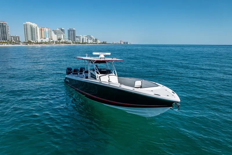 Slide: The Image of 2018 Nor-Tech 390 Sport Center Console boat on ocean, city skyline in background. - 26