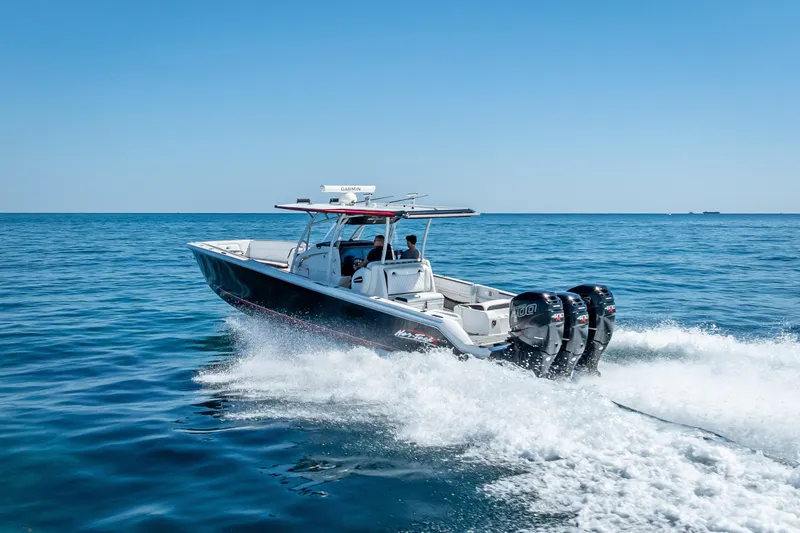 Slide: The Image of 2018 Nor-Tech 390 Sport Center Console cruising on open water. - 28