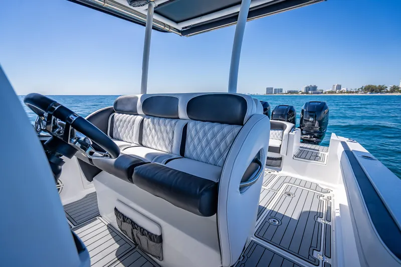 Slide: The Image of 2018 Nor-Tech 390 Sport Center Console boat interior with luxurious seating on open water. - 3