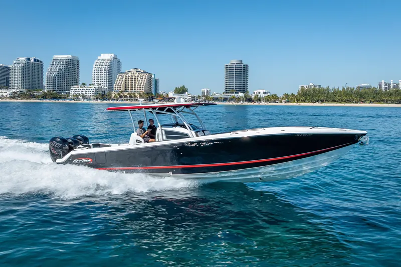 Slide: The Image of 2018 Nor-Tech 390 Sport Center Console cruising near city skyline. - 30