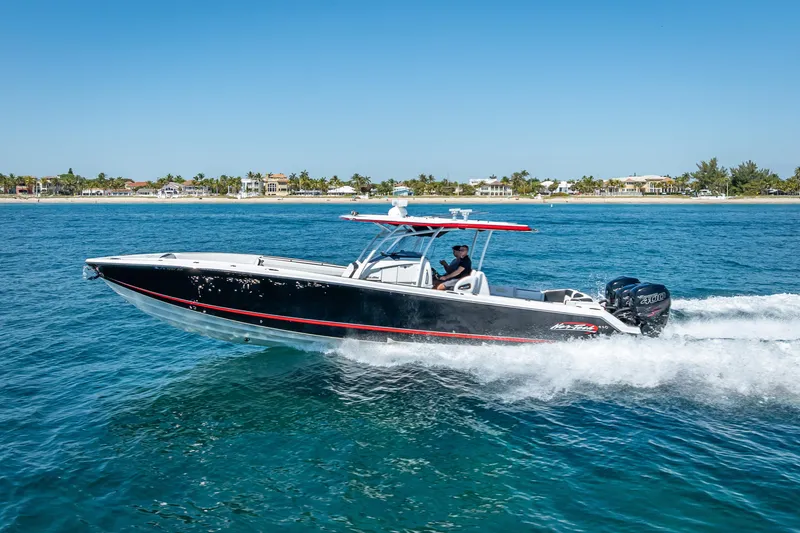 Slide: The Image of 2018 Nor-Tech 390 Sport Center Console cruising on blue ocean waters. - 34