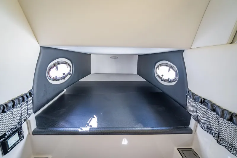 Slide: The Image of Interior cabin of 2018 Nor-Tech 390 Sport Center Console with portholes and storage nets. - 37