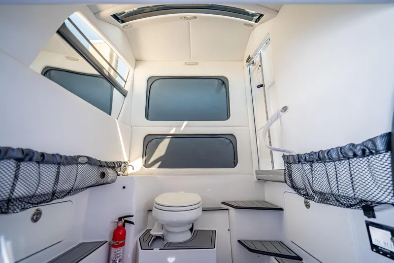 Slide: The Image of Interior of 2018 Nor-Tech 390 Sport Center Console boat with toilet and storage. - 38