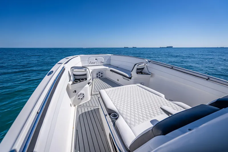 Slide: The Image of 2018 Nor-Tech 390 Sport Center Console boat on open sea, featuring luxurious seating. - 39