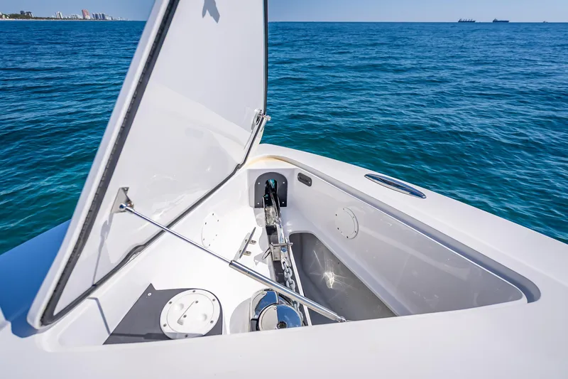 Slide: The Image of Open anchor compartment on 2018 Nor-Tech 390 Sport Center Console boat, ocean background. - 40