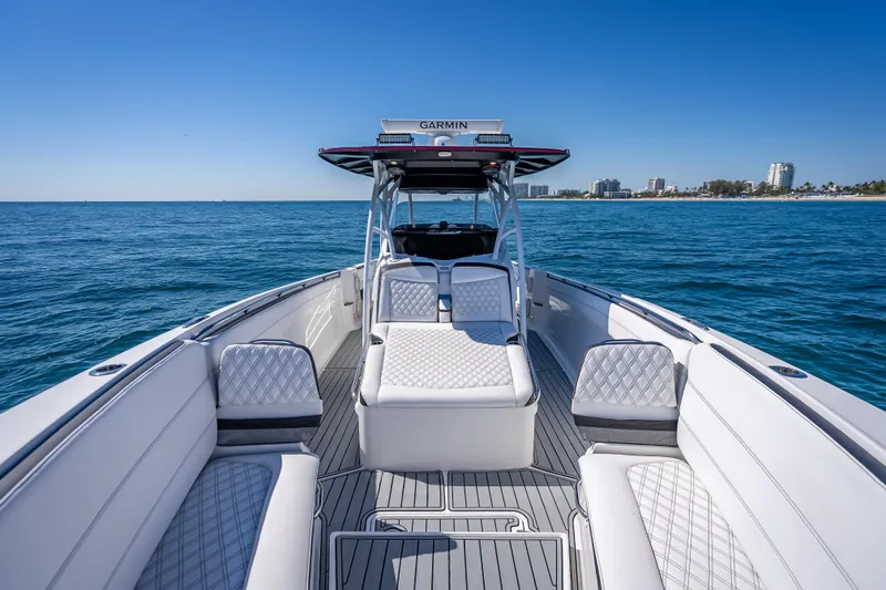 Slide: The Image of 2018 Nor-Tech 390 Sport Center Console boat on open water, featuring luxurious seating. - 41