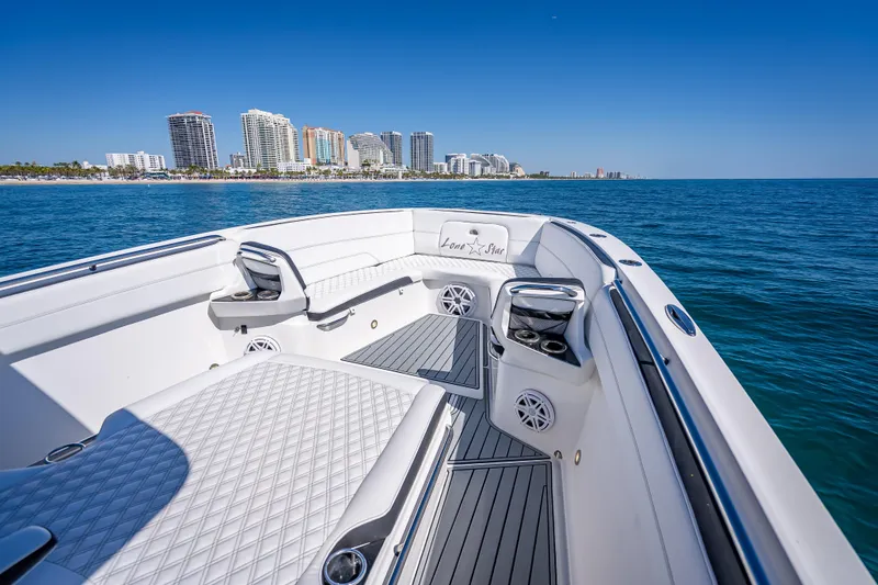 Slide: The Image of 2018 Nor-Tech 390 Sport Center Console boat on ocean, city skyline in background. - 42