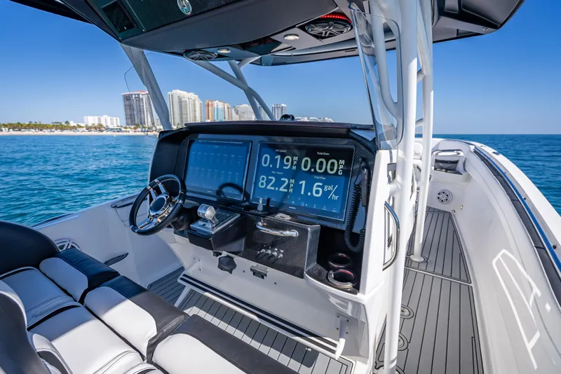 Slide: The Image of 2018 Nor-Tech 390 Sport Center Console boat interior with advanced navigation display. - 45