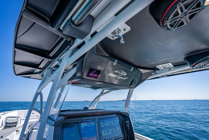 Slide: The Image of 2018 Nor-Tech 390 Sport Center Console on open water, featuring advanced navigation equipment. - 47