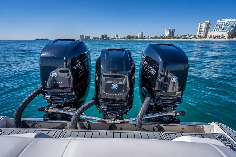 Slide: The Image of 2018 Nor-Tech 390 Sport Center Console with triple outboard engines on blue ocean. - 7