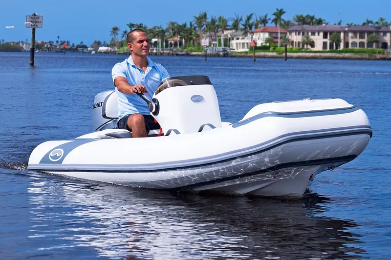 Slide: The Image of Manufacturer Provided Image: Man driving 2025 Walker Bay Generation 11 LTE boat on calm water. - 4