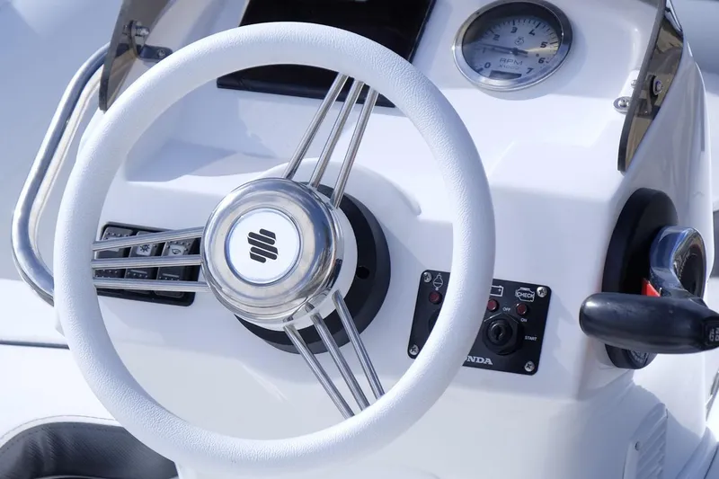 Slide: The Image of Manufacturer Provided Image: Steering wheel of 2025 Walker Bay Generation 11 LTE boat, featuring modern controls. - 9