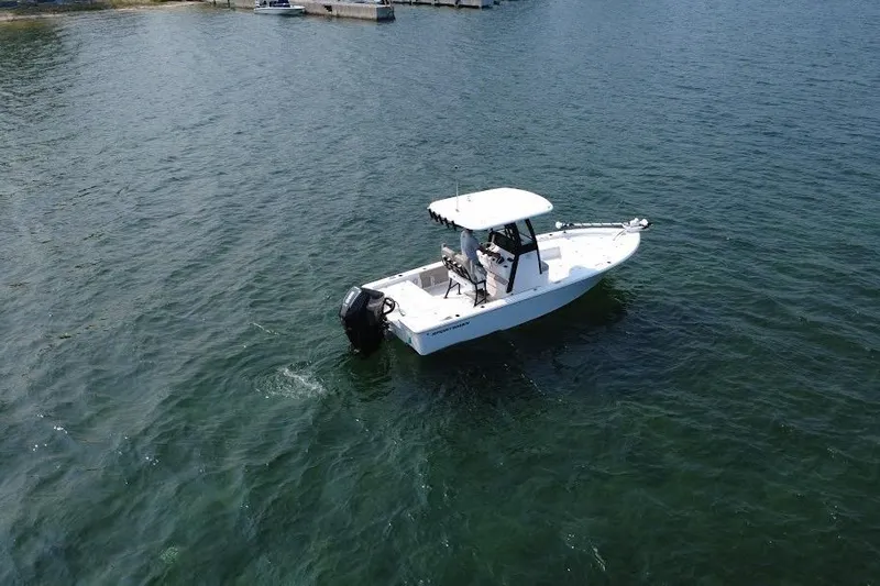 Slide: The Image of 2025 Sportsman Masters 227 Bay Boat on calm water, aerial view. - 3