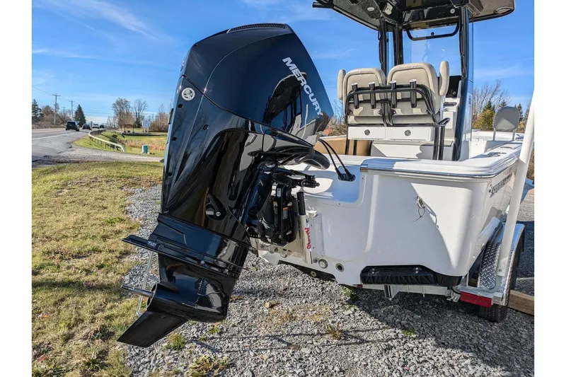 Slide: The Image of 2025 Sportsman Masters 227 Bay Boat with Mercury outboard engine on a trailer. - 5