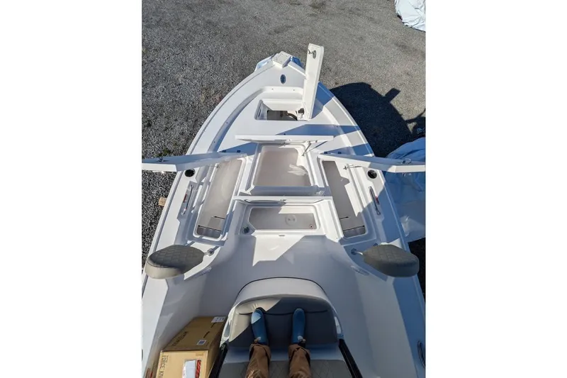 Slide: The Image of 2025 Sportsman Masters 227 Bay Boat deck view with storage compartments open. - 8