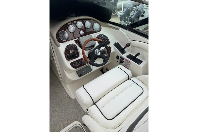 Slide: The Image of 2005 Sea Ray 290 SLX boat cockpit with steering wheel and control panel. - 5