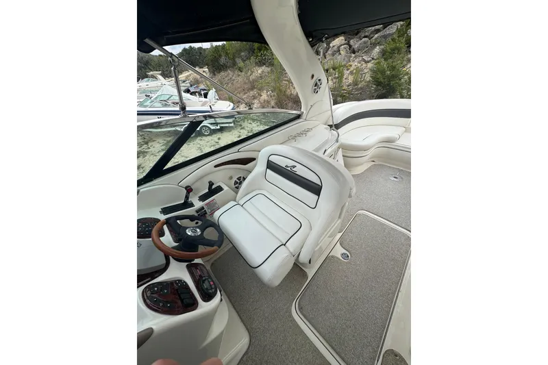 Slide: The Image of 2005 Sea Ray 290 SLX boat interior with steering wheel and seating area. - 6