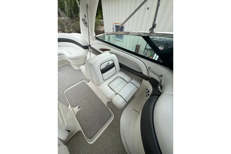 Slide: The Image of Interior of a 2005 Sea Ray 290 SLX boat with white seating and carpeted floor. - 8