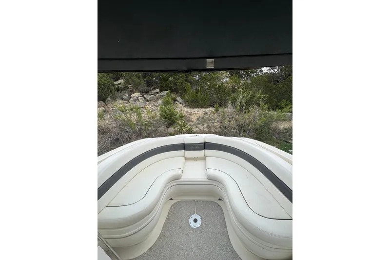 Slide: The Image of 2005 Sea Ray 290 SLX boat interior with white seating and outdoor view. - 9