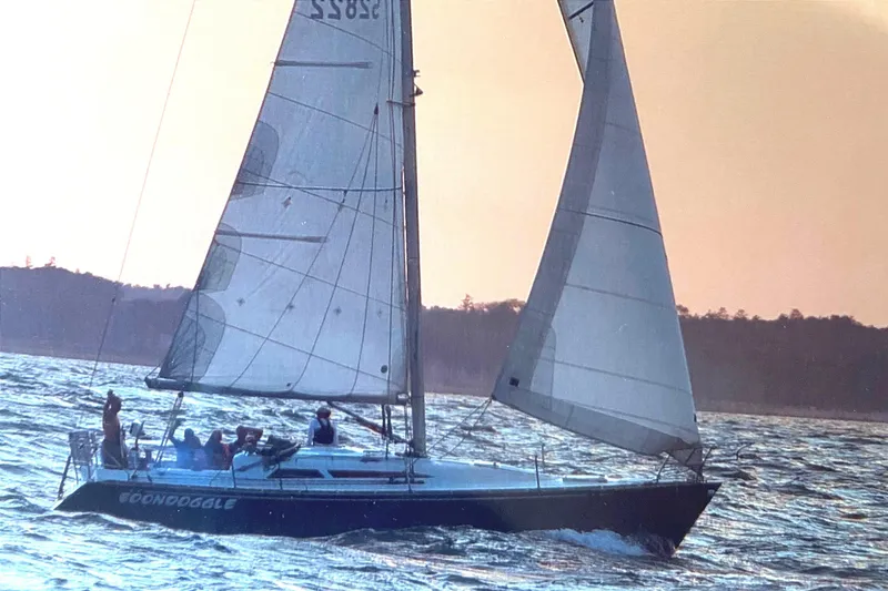 The Image of Sailboat "Boondoggle" on water at sunset, C&C 110 model, 2001. - 0
