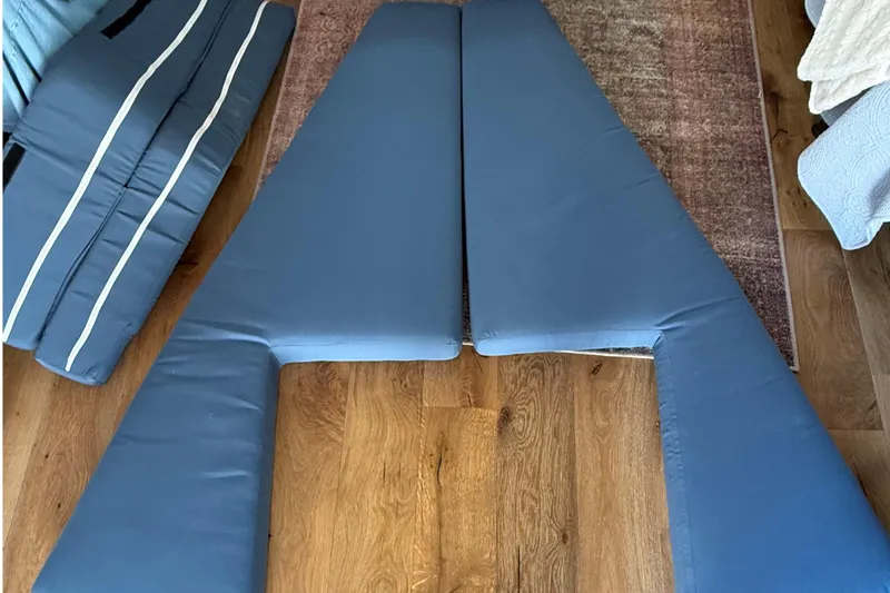 Slide: The Image of Blue boat cushions on wooden floor, C&C 110 model, 2001. - 11