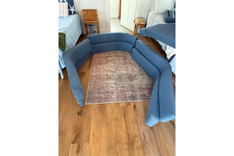 Slide: The Image of Blue inflatable sofa on a wooden floor, near a patterned rug in a cozy room. - 13