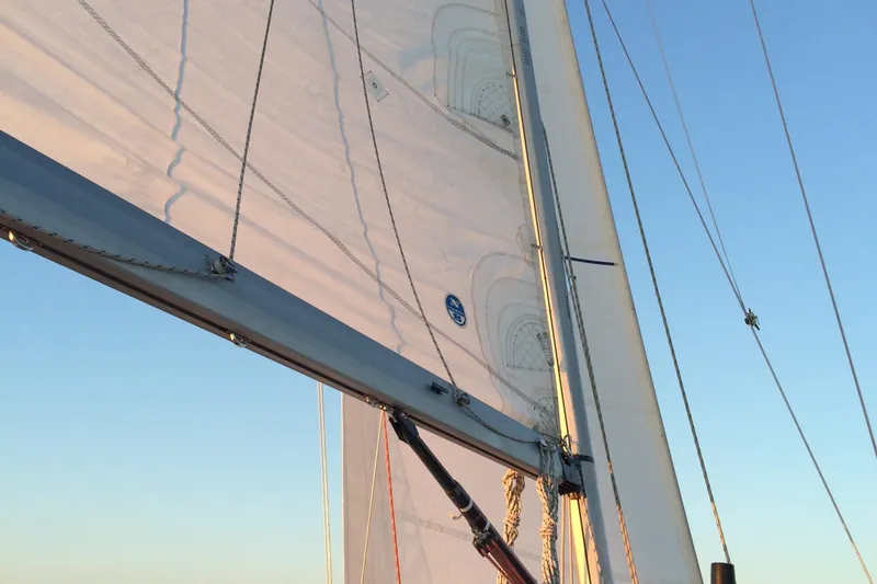 Slide: The Image of Sailboat with white sails against a clear blue sky, C&C 110 model, 2001. - 7