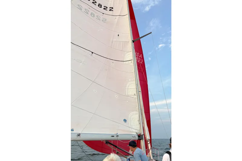 Slide: The Image of Sailboat with red and white sails on open water, C&C 110 model, 2001. - 8