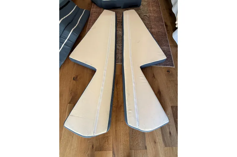 Slide: The Image of C&C 110 boat cushions, beige and blue, on wooden floor, 2001 model. - 9