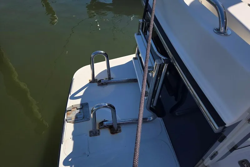 Slide: The Image of 2010 American Tug "34" Pilothouse Trawler stern with stainless steel railings and ladder. - 101