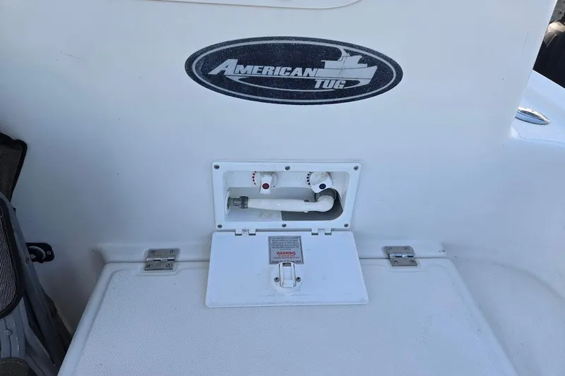 Slide: The Image of American Tug 34 Pilothouse Trawler 2010, deck detail with logo and utility compartment. - 103