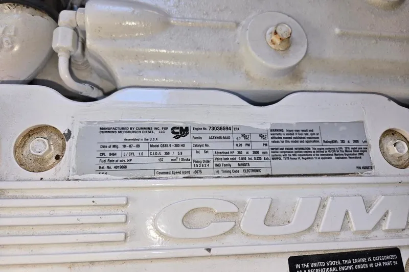 Slide: The Image of Engine label on a 2010 American Tug "34" Pilothouse Trawler, featuring Cummins specifications. - 106