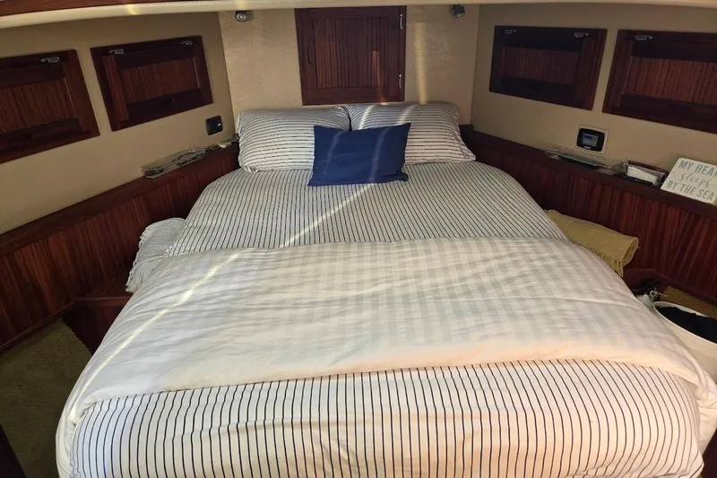 Slide: The Image of Cozy bedroom in 2010 American Tug "34" Pilothouse Trawler with striped bedding. - 11