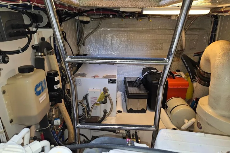 Slide: The Image of Engine room of a 2010 American Tug "34" Pilothouse Trawler, featuring equipment and storage. - 111