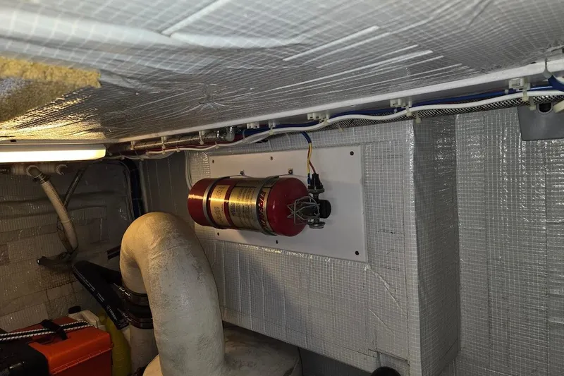 Slide: The Image of Engine room of 2010 American Tug "34" Pilothouse Trawler with fire extinguisher mounted on wall. - 113