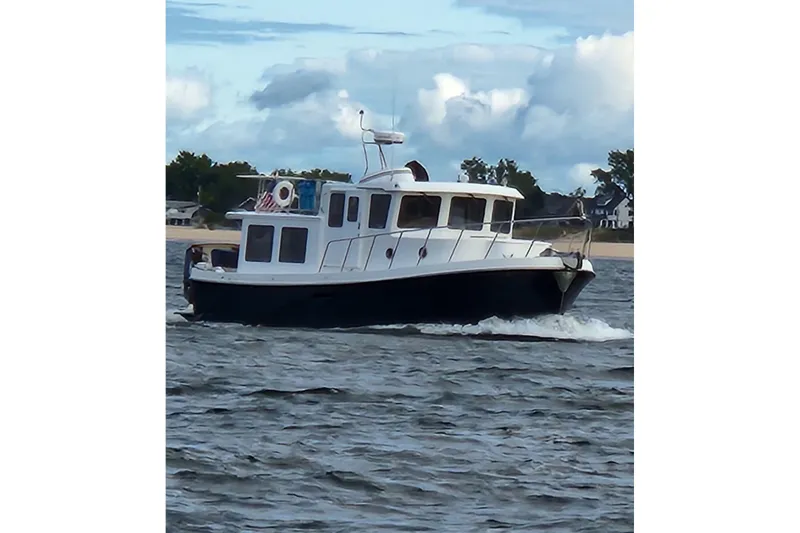 Slide: The Image of 2010 American Tug "34" Pilothouse Trawler cruising on open water. - 118